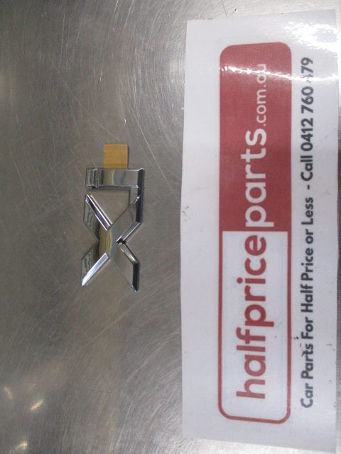 Mitsubishi Magna/Verada Genuine Chrome Xi Emblem New Part