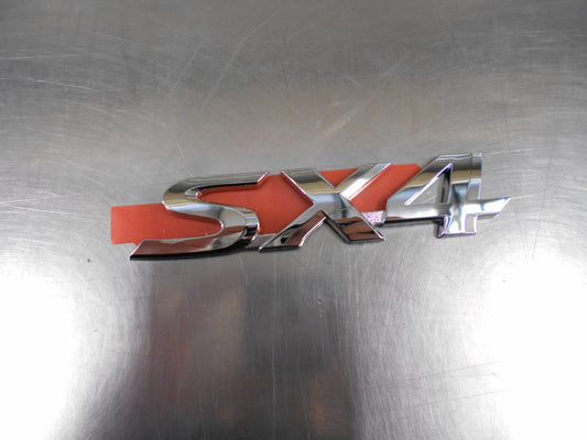 Suzuki SX4 Genuine Emblem Nameplate New Part